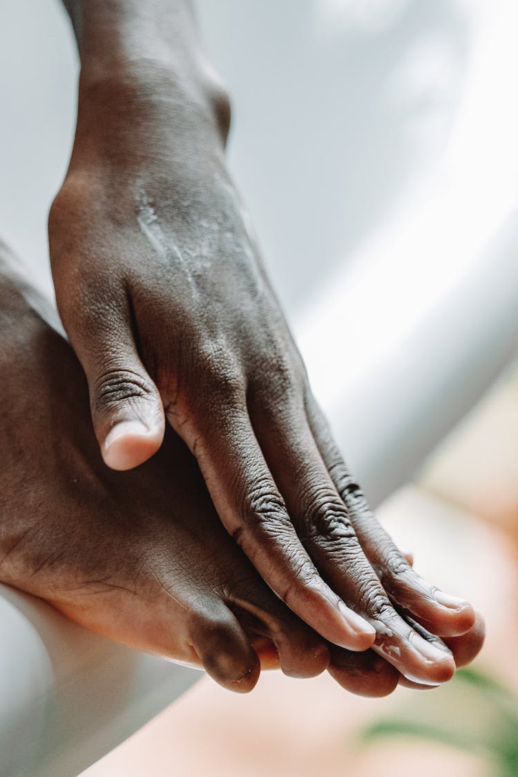 Close-up Of Woman Touching Her Foot 