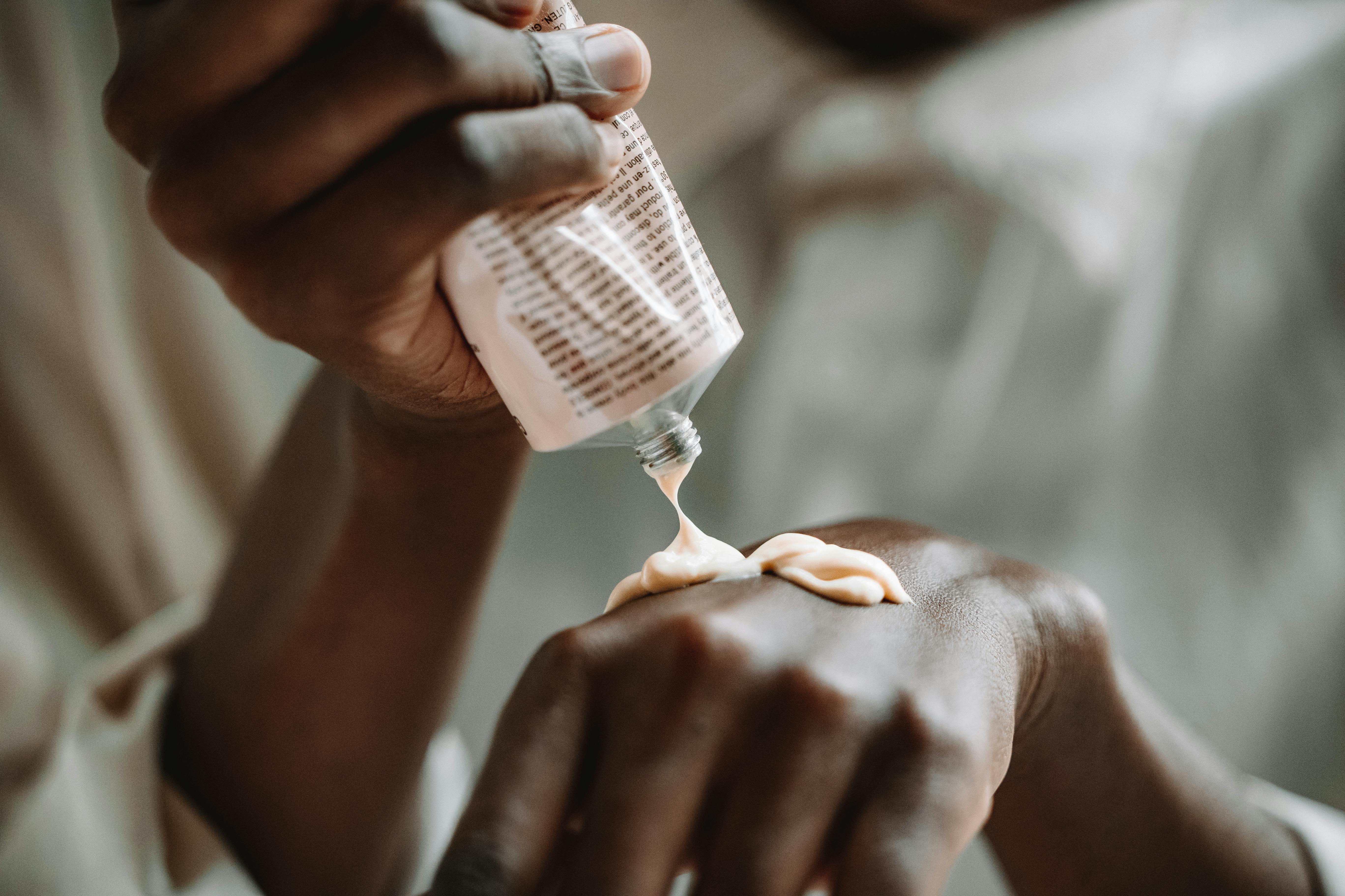 a person putting cream on hand