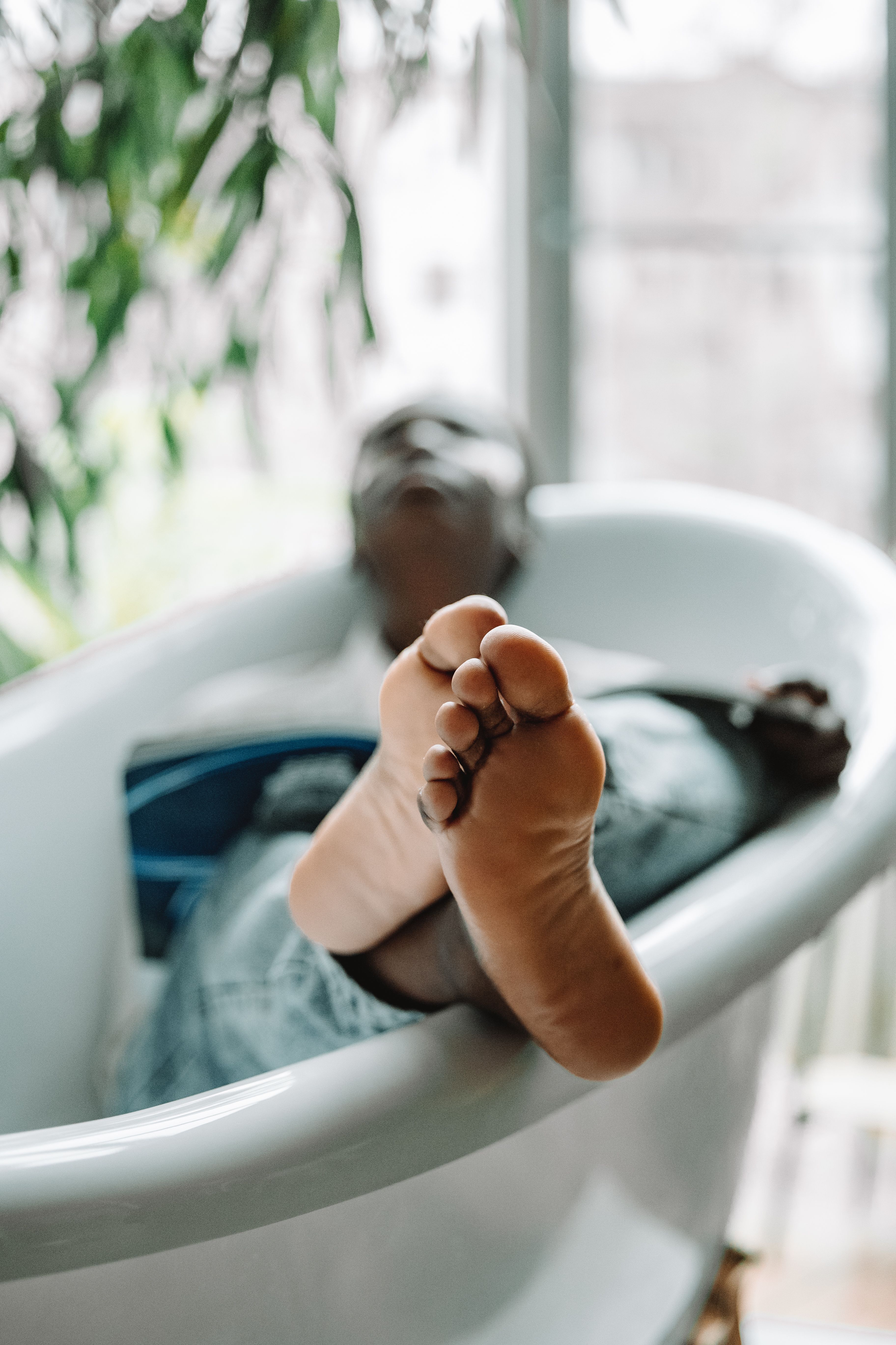 a person stepping onto a digital bathroom scale in a bright bathroom