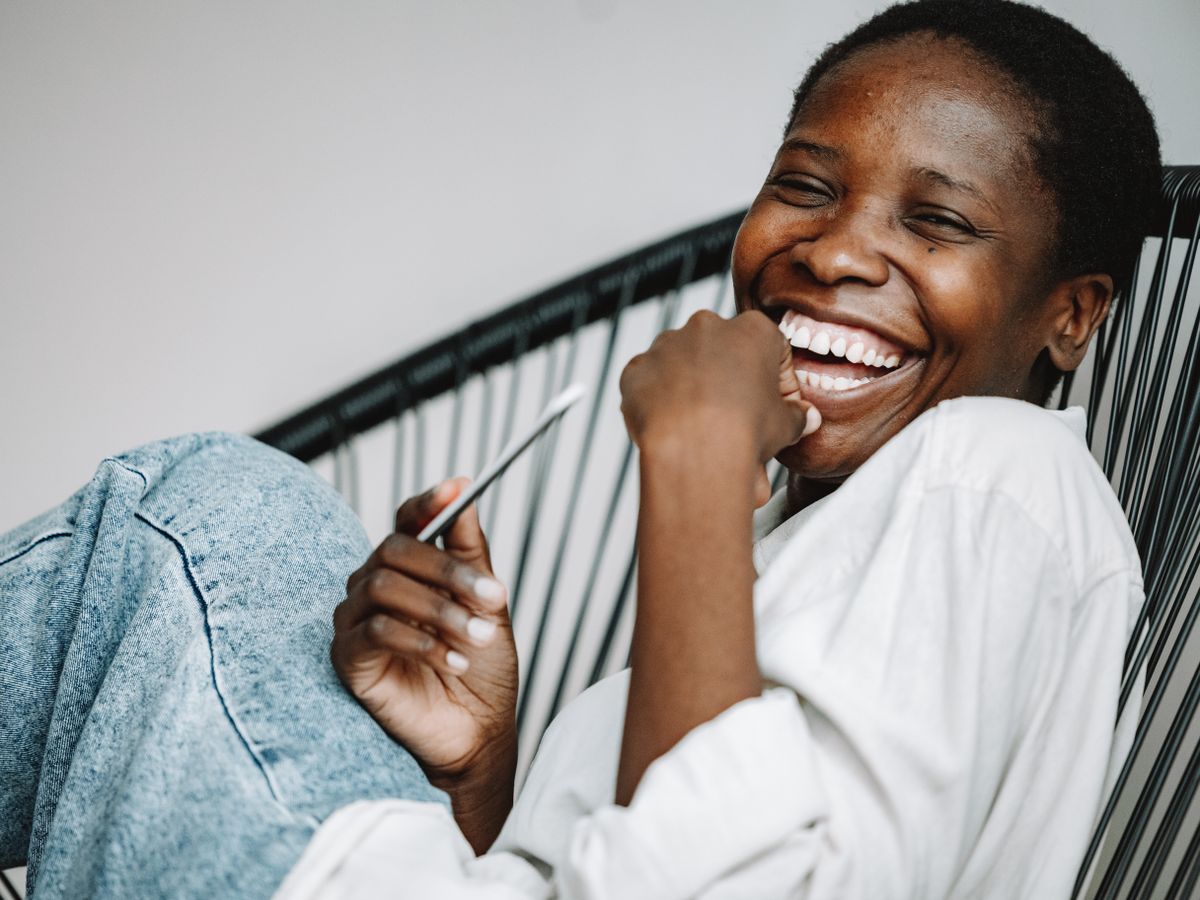 Client laughing while relaxing at home