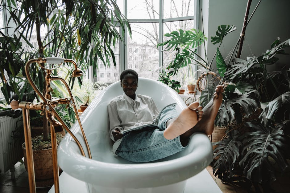 Woman Wearing Denim Jeans Lying in the Bathtub