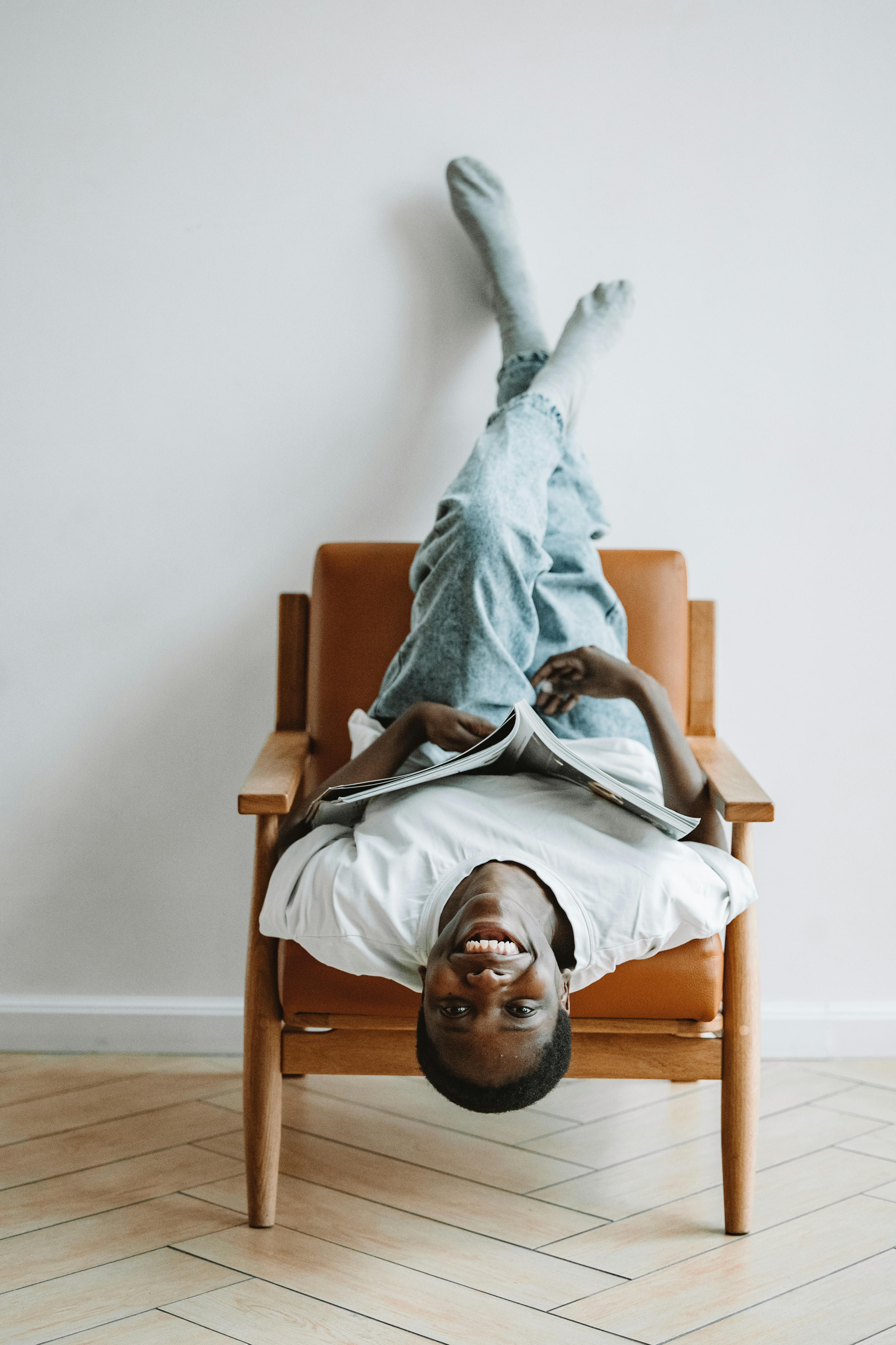 Woman Sitting on Chair Upside Down Free Stock Photo