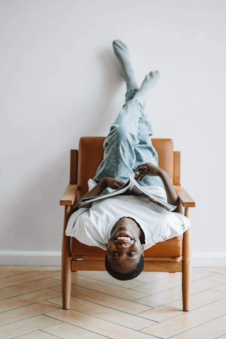 Woman Sitting On Chair Upside Down