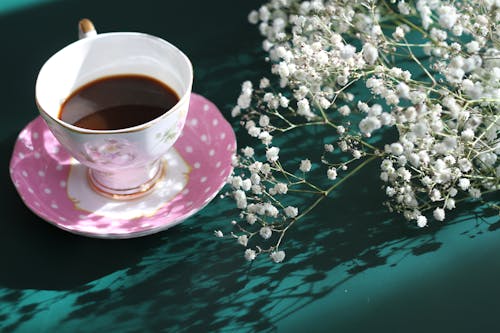 Free Close up of a Cup of Coffee and Flowers Stock Photo