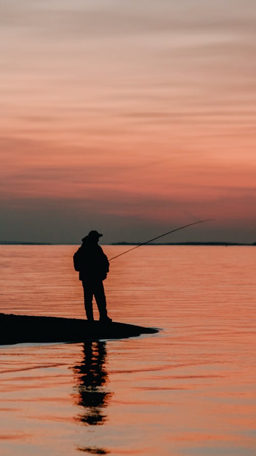 Silhouette of a Fisherman at Sunset 