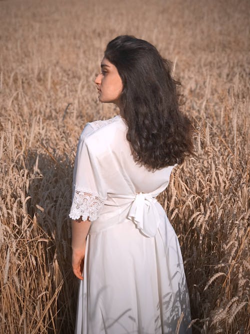 Woman in White Dress Standing in the Field