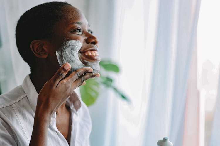 Person Applying Shaving Cream On Face