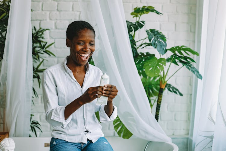 Laughing Woman Squeezing Moisturizer Form A Tube 