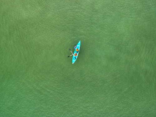 Free People on a Blue Kayak Stock Photo