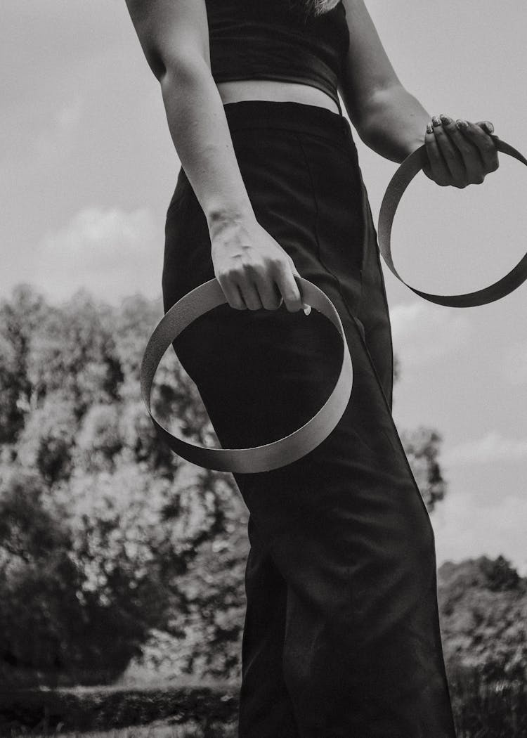 A Woman Holding A Pair Of Hoops