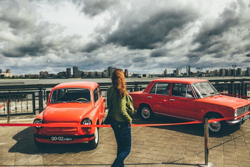 A Woman Looking the Classic Cars
