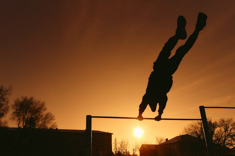 Silhouette Of Person On Pull Up Bar