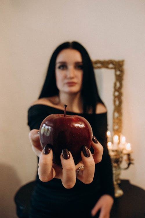 Woman Holding a Red Apple 
