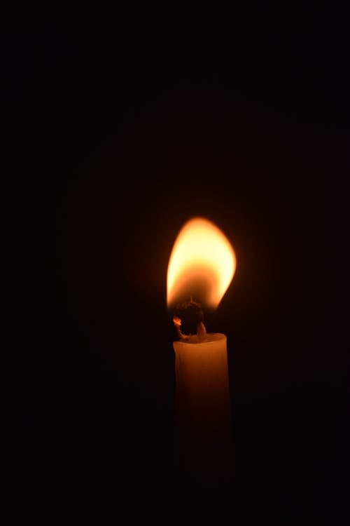 Close-up Photo of a Lighted Candle 