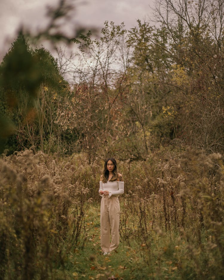 A Woman Surrounded By Dried Plants