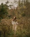 Woman in Sweater Walking on Path