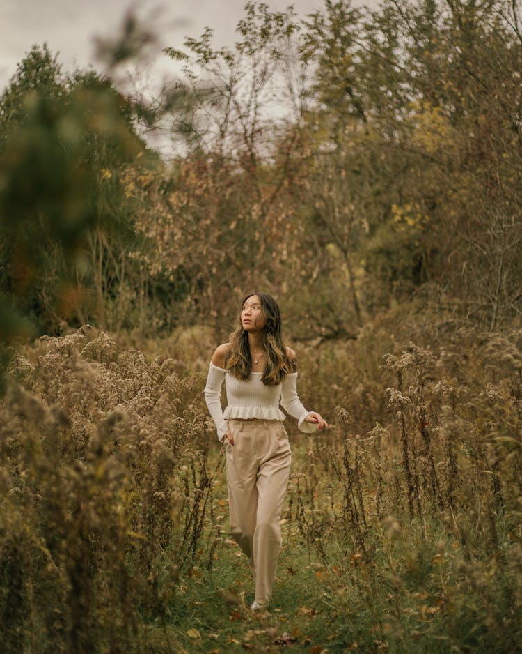 Woman In Sweater Walking On Path