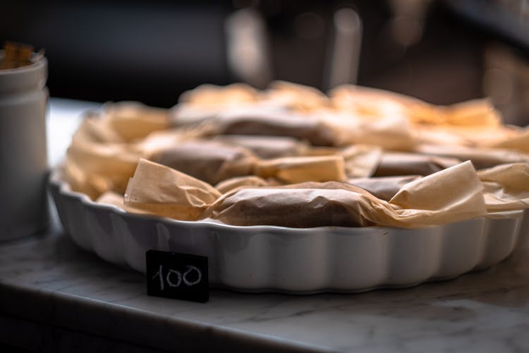 A Price Tag Beside A Tray Of Wrapped Food Products