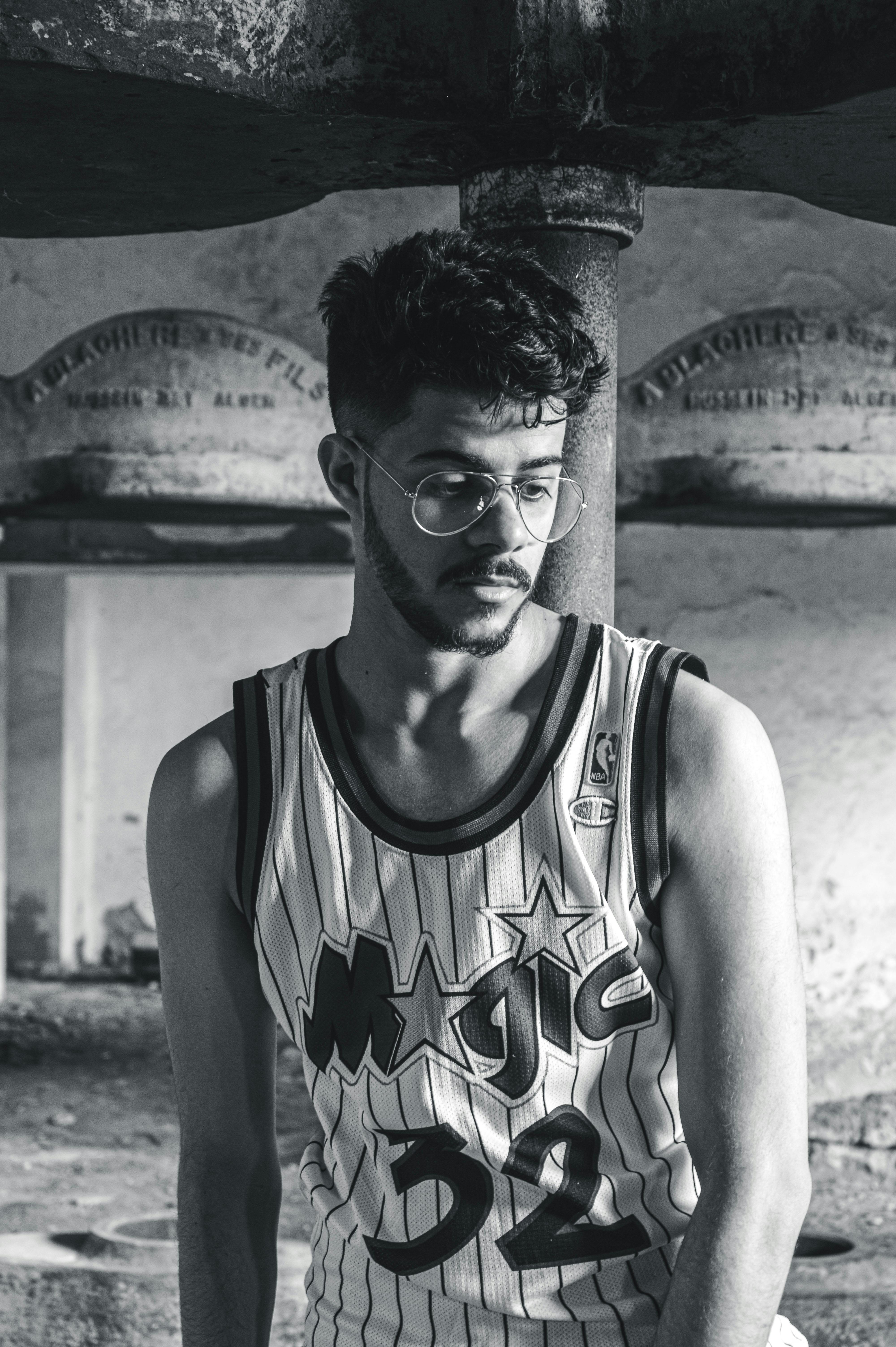 a bearded man in tank top shirt wearing eyeglasses