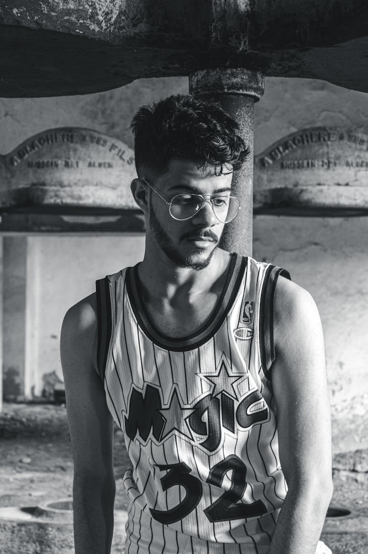 A Bearded Man In Tank Top Shirt Wearing Eyeglasses