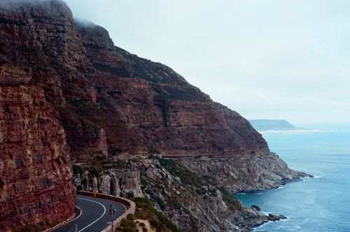Free Breathtaking view of a winding road along the cliffs by the ocean in South Africa. Stock Photo