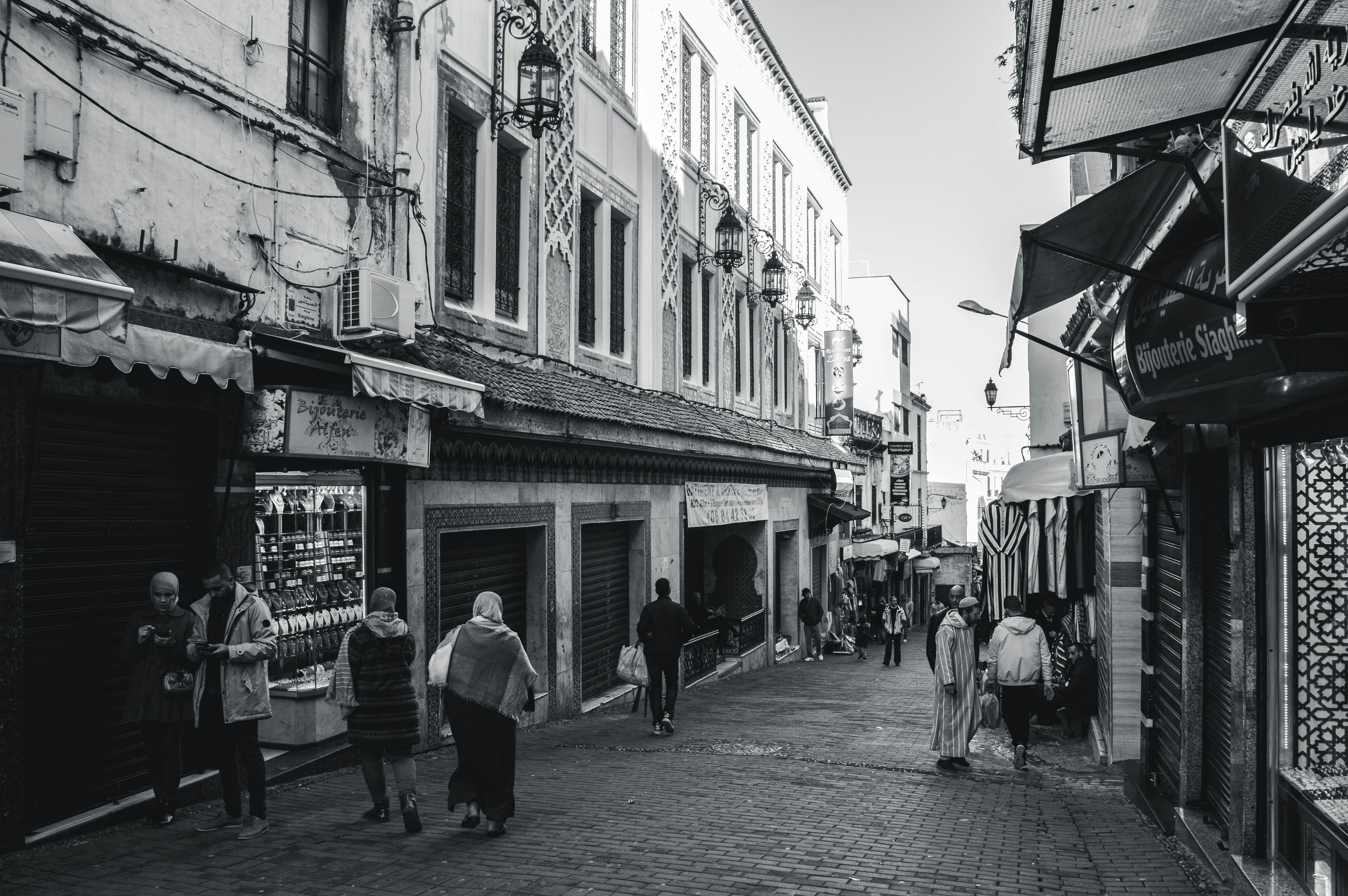 A captivating black and white image of a bustling street in Tangier, Morocco with pedestrians.