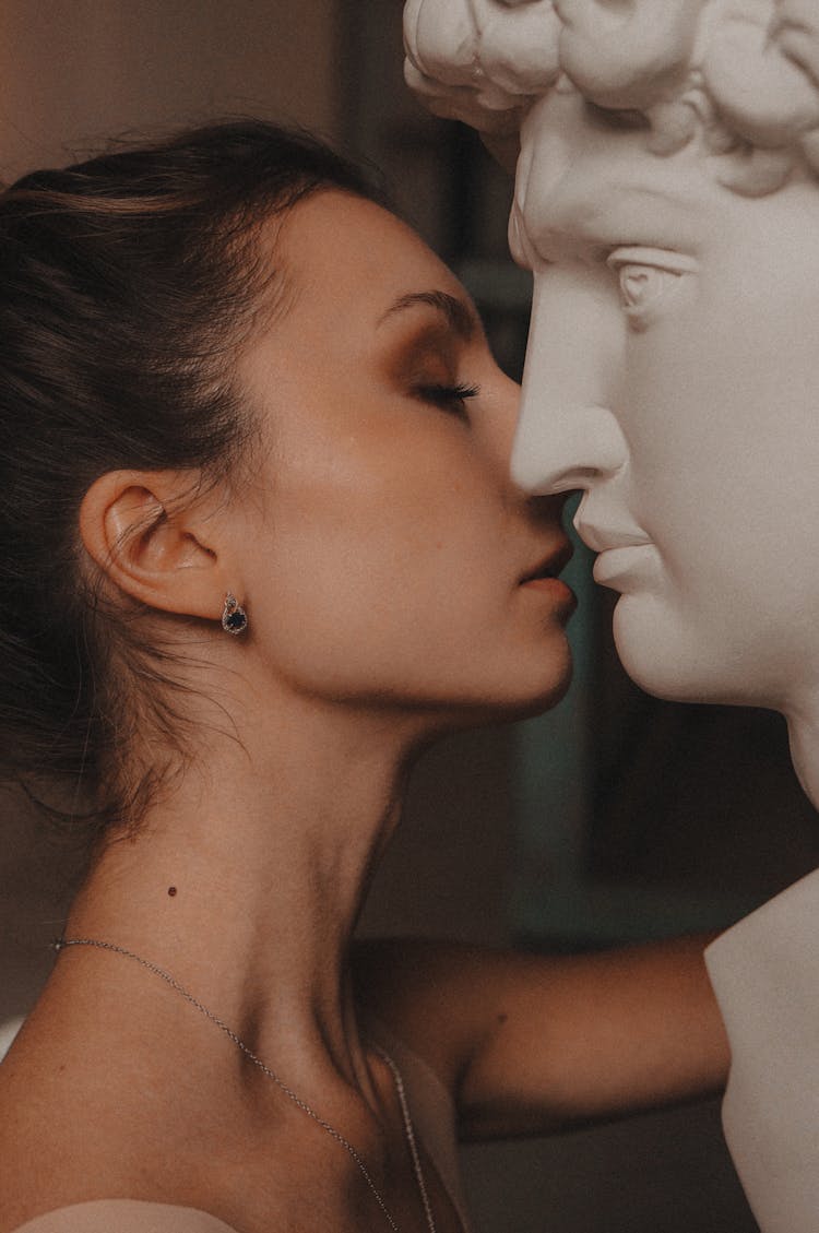 Woman Kissing A Statue