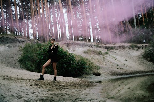 Woman in Black Dress Standing on a Forest