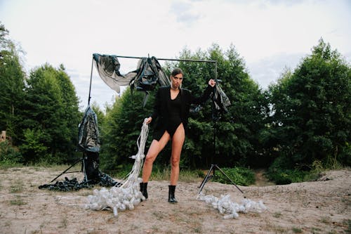 A Woman Posing with Plastic in Forest