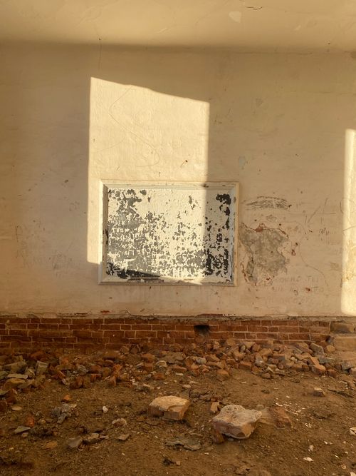 Free Sunlight casts shadows on an abandoned, textured wall in a decaying building, capturing urban decay. Stock Photo