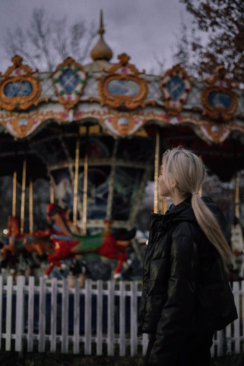 Shallow Focus of a Woman Wearing Black Winter Coat at Amusement Park Ride