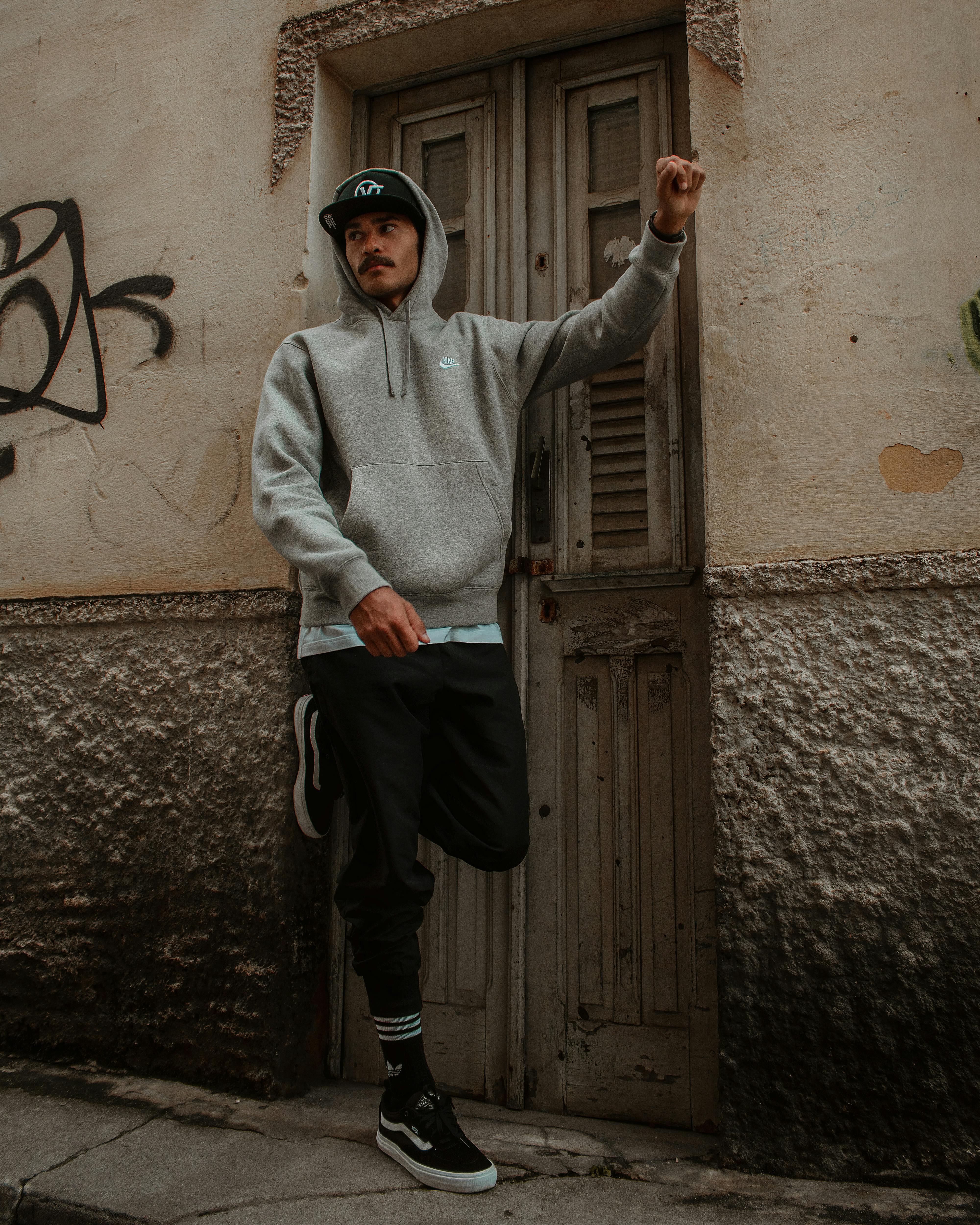 Man in Hoodie Posing near Door · Free Stock Photo