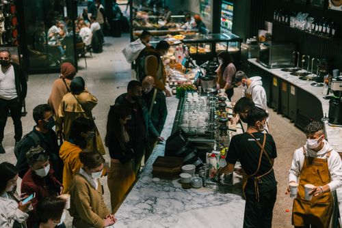 Free People gather in a lively coffee shop in Istanbul, showcasing baristas at work. Stock Photo