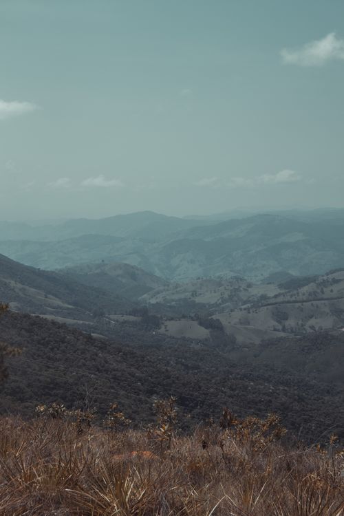 Free A tranquil mountain vista with layered hills under a clear blue sky, showcasing nature's beauty. Stock Photo