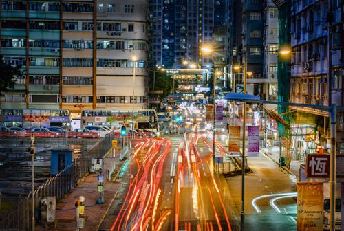 Free Vibrant Hong Kong street scene with light trails and city lights at night, showcasing busy urban life. Stock Photo
