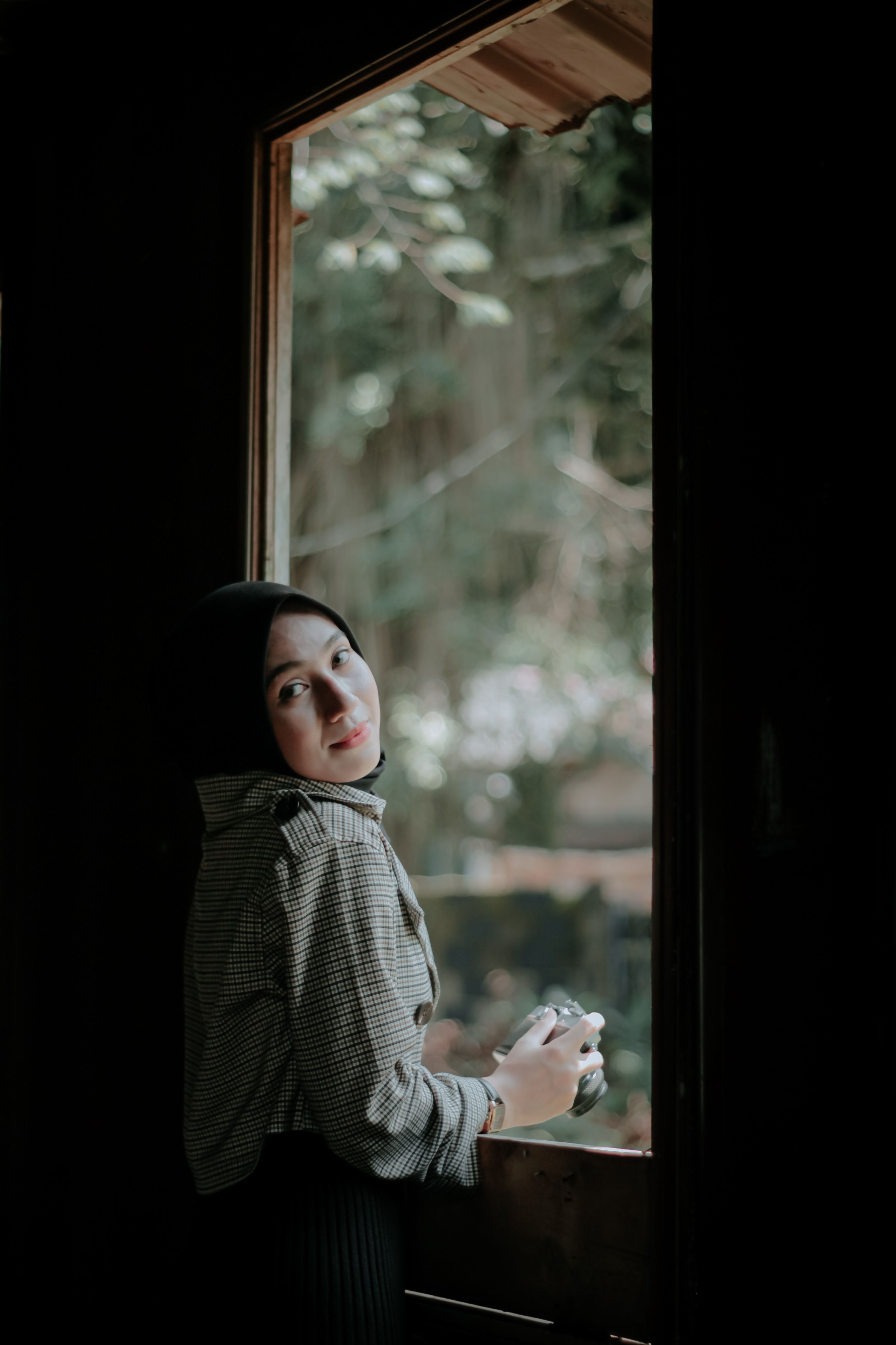 A Woman Standing Beside the Wooden Window · Free Stock Photo