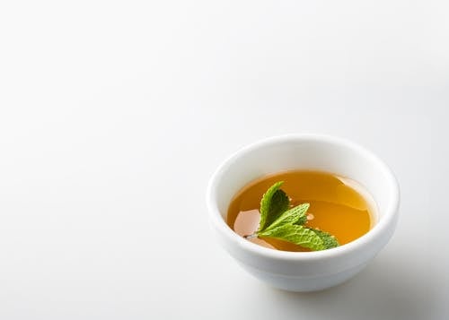 White Ceramic Cup With Green Leaf