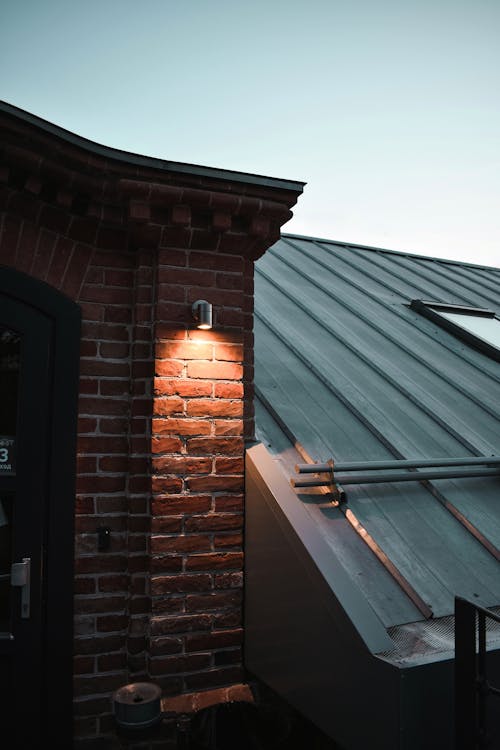 Brown Brick Wall With Light Fixture on the Roof