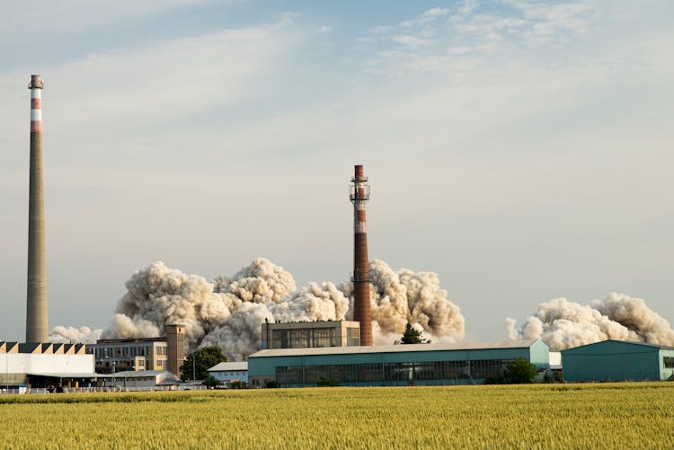 Factory Buildings Against Cloudy Sky