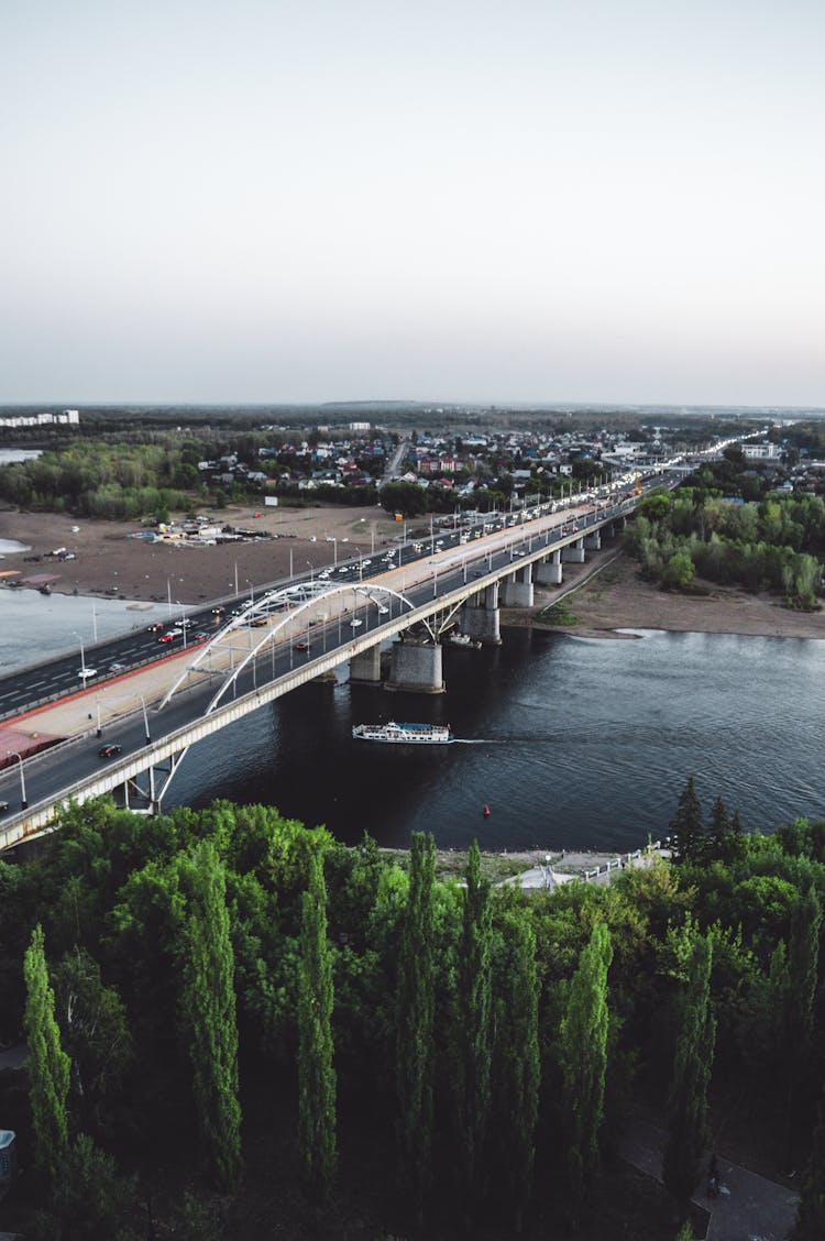 Ship Under A Bridge Over A River