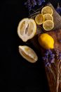 Slices and Wedges of Yellow Lemon Arranged with Blue Flowers