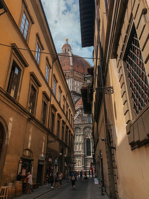 Free Capture the charming view of Florence's Duomo through an historic narrow street. Stock Photo