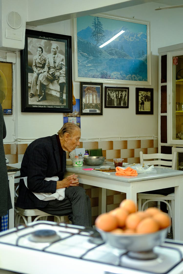 Elderly Man Sitting At The Table 