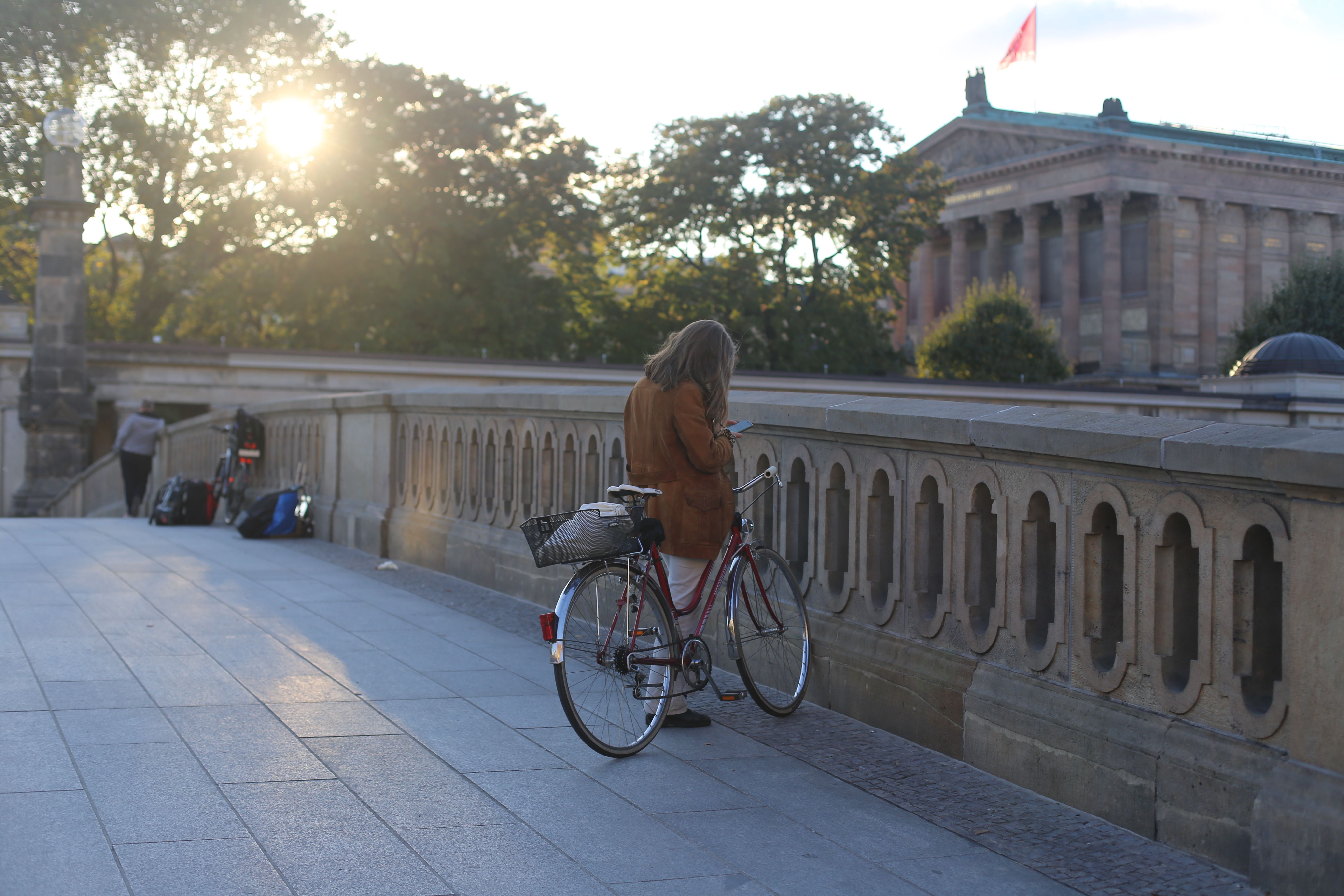 A Woman Standing Beside Her Bicycle · Free Stock Photo