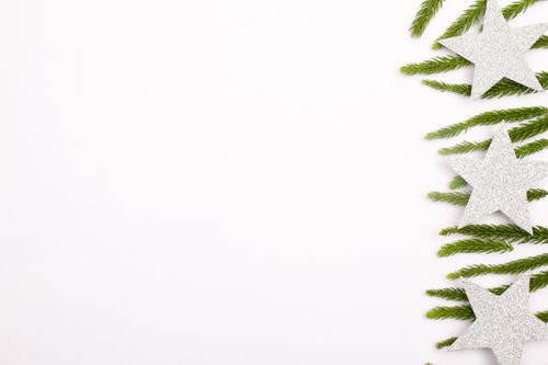 Free White background with silver stars and pine branches, perfect for holiday designs. Stock Photo