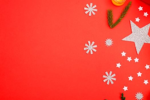 A vibrant red surface with festive Christmas ornaments and decorations, perfect for holiday themes.