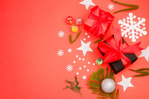 Free Decorative Christmas gifts on a red background with stars and snowflakes. Perfect for holiday themes. Stock Photo