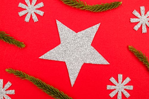 Close-Up Shot of Christmas Ornaments on Red Surface
