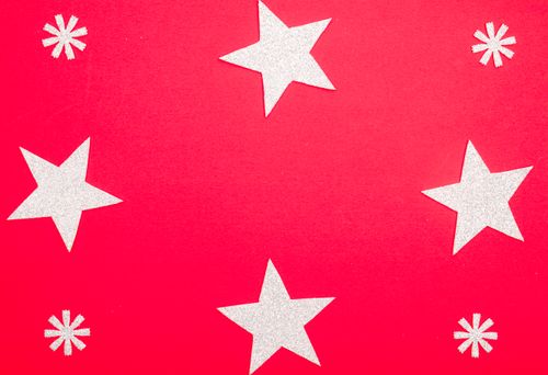 Free A vibrant red background adorned with silver stars, perfect for seasonal celebrations. Stock Photo