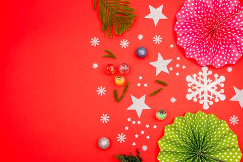 Free Top view of Christmas decorations with ornaments on red surface, perfect for holiday themes. Stock Photo